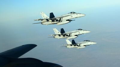 A formation of US navy F-18E Super Hornets leaves after receiving fuel from a KC-135 Stratotanker over northern Iraq as part of US-led coalition airstrikes on ISIL and other targets in Syria. Staff Sgt. Shawn Nickel / US air force / AP Photo