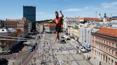 Danish street artist Martin Maartonsson performs on a tightrope above Ban Jelacic Square during the Cest is d'Best International street festival in Zagreb, Croatia. EPA
