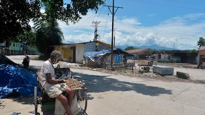 A street vendor waits for customers at a deserted market in Siliguri, India, on June 15, 2020, after the government relaxed a lockdown that was in force to prevent the spread of Covid-19. AFP