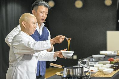 Jeong Kwan, a Buddhist monk and philosopher chef, with interpreter Kim Jihoon at a cooking session in the Korean Cultural Centre. Khushnum Bhandari for The National