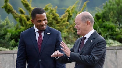 German Chancellor Olaf Scholz, right, with Gambia's Minister of Information Ismaila Ceesay. AFP