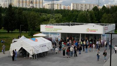 People wait in line to get a Covid-19 vaccine at a park in the outskirts of Moscow. Russia has seen a recent surge in cases.