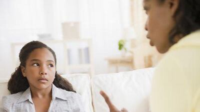 Mother lecturing daughter in living room