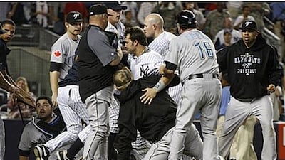 The Blue Jays and the Yankees clash during the eighth inning.