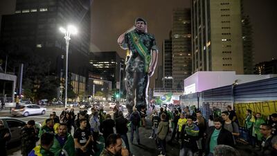 Supporters of presidential candidate Jair Bolsonaro install a giant inflatable doll with the image of General Hamilton Mourao, Vice President candidate of Bolsonaro on Avenida Paulista in Sao Paulo, Brazil. EPA