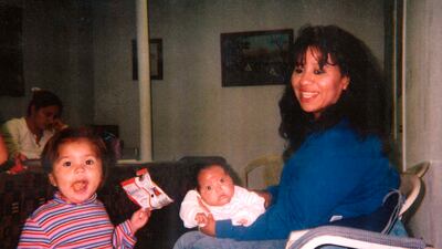 Texas death row inmate Melissa Lucio holds her baby daughter Mariah, while one of her other daughters, Adriana, stands next to them. AP