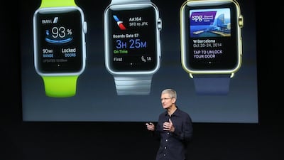 Tim Cook stands in front of a screen displaying apps available for the Apple Watch during a presentation in October. Robert Galbraith / Reuters