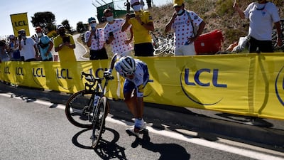 Team Deceuninck rider Julian Alaphilippe waits for support after crashing. AFP