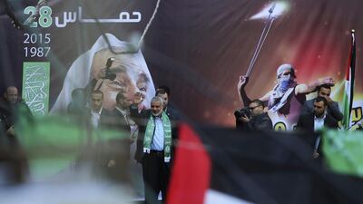 Hamas leader Ismail Haniyeh waves to supporters during a rally on December 14, 2015, to commemorate the 28th anniversary of the Hamas in Gaza City. Hamas has drafted a new political program that it hopes will present a more moderate image and help it get off Western terrorism lists. Adel Hana / AP