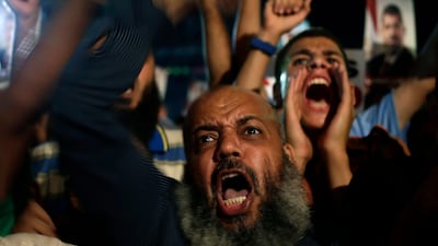 The army, saying it was aware of the planned march, issued a statement urging protesters "not to come close to military facilities in general, and the headquarters of military intelligence specifically." Hassan Ammar / AP Photo