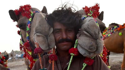 A man sells camels at a market in the lead up to Eid Al Adha, in Karachi, Pakistan. EPA
