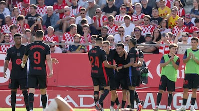 Barcelona midfielder celebrates with teammates scoring his team's fourth goal. AFP