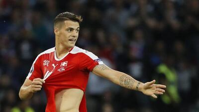 Switzerland midfielder Granit Xhaka has his shirt ripped after a challenge by France midfielder Paul Pogba. Gonzalo Fuentes / Reuters