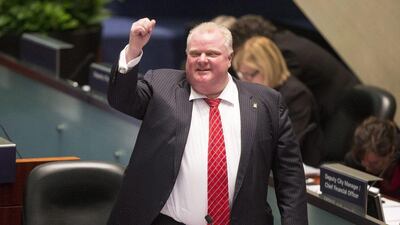 Toronto Mayor Rob Ford raises his fist in a mock salute during a chaotic council session. Chris Young / The Canada Press / AP Photo