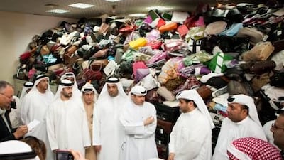 Sami Dhaen Al Qamzi, Director General of the Department of Economic Development, showcases the departments largest collection of confiscated counterfeit goods.