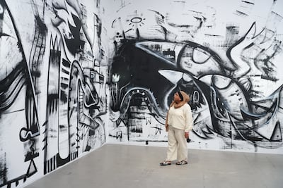 Fatspatrol (Fathima Mohiuddin) used brooms to paint The World Out There. Photo: Ishara Art Foundation