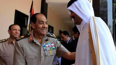 Field Marshal Hussein Tantawi, head of the Egyptian Armed Forces Supreme Council, greets Qatari Crown Prince Sheikh Tamim bin Hamad Al Thani , who is now Qatar’s emir, in Cairo in June, 2011.