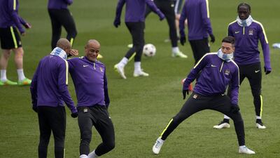 Manchester City captain Vincent Kompany, second left, takes part in training along with Samir Nasri, second right. Oli Scarff / AFP