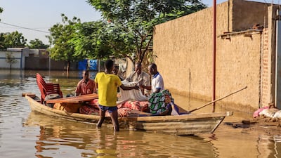 Residents try to salvage items from houses submerged by floods in N'Djamena, Chad, on October 18, 2022. AFP
