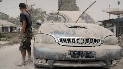 Ash from Mount Sinabung volcano covers a car and street following an eruption in Karo, North Sumatra, Indonesia. Antara Foto / Surianto Sembiring / via Reuters