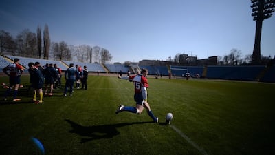 A Russia rugby union player kicks the ball during warmups prior to playing Crimea rugby union on Saturday. Filippo Monteforte / AFP / March 15, 2014