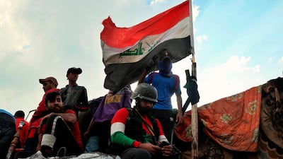 Protesters stage a sit-in on barriers at the Ahrar Bridge during ongoing anti-government protests in Baghdad, Iraq. AP Photo