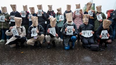 Activists hold placards forming the slogan 'You embarrass us Belgium' during a protest outside the Cop26 venue. EPA