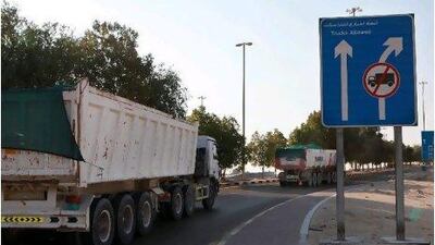 Lorries carrying raw materials to the Sheikh Khalifa Port construction site have become a frequent sight in Al Samha.