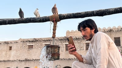 A man relaxes next to a water fountain outside Qatar's Souq Waqif bazar in Doha. AFP