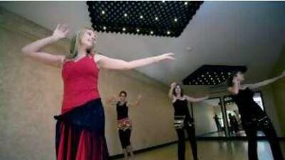 Elina Nykanen Rozycki, left, owner of Yoga Tree, leads a belly dancing class.