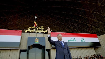 Iraqi Prime Minister Mustafa Al Kadhimi waves during a ceremony in Baghdad to mark the Iraqi armed forces centenary on January 6, 2021. Iraqi Prime Minister Media Office via Reuters