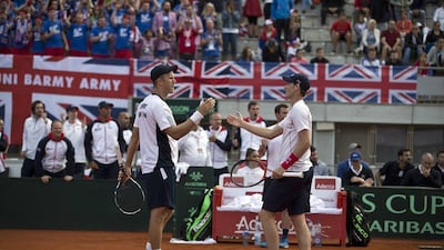 Britain's Dominic Inglot, left, and Jamie Murray shake hands after they won their Davis Cup quarterfinal tennis doubles match against Serbia's Nenad Zimonjic and Filip Krajinovic in Belgrade, Serbia, Saturday, July 16, 2016. Marko Drobnjakovic / AP Photo