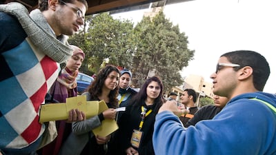 Volunteers of the anti-sexual harassment organisation, Harassmap, during a street awareness campaign in Cairo. About 65 per cent of young Egyptians said they would want to live in the UAE. Photo: Alamy