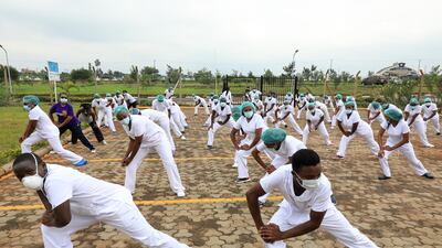 Kenyan nurses, midwives and other frontline workers working at the Infectious Disease Unit at the Kenyatta University Teaching, Referral and Research Hospital, during a Zumba training session organised by the Nursing Council of Kenya, May 17. The event was organised with the aim of boosting the frontline health workers' mental health as the pandemic rages on. Daniel Irungu / EPA