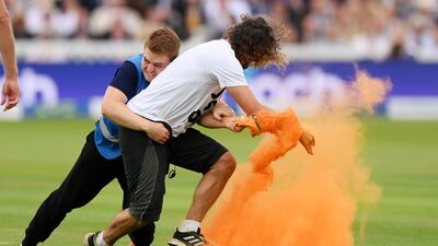 A Just Stop Oil protester is tackled by security during the opening day of the second Ashes Test at Lord's. Getty