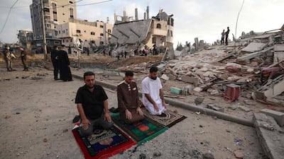 Palestinian Muslim perform the morning Eid Al-Fitr prayer outdoors amid the destruction, following two days of Israeli airstrikes on Gaza, in Beit Lahia in the northern Gaza Strip. AFP