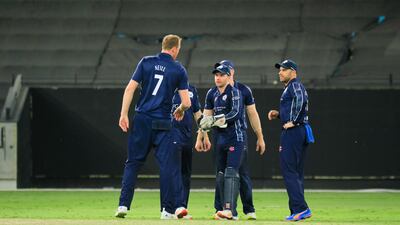 Scotland players celebrate during the match against Oman in Dubai. Photo: ICC