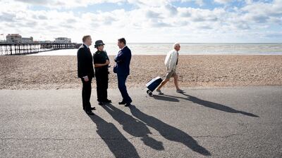 Shadow home secretary Nick Thomas-Symonds, left, is joined by Keir Starmer as they meet members of the Sussex Police force on a walkabout in Worthing. PA