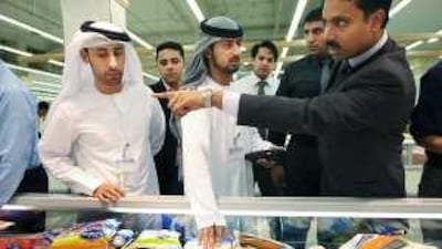 Inspectors from Abu Dhabi's Food Control Authority examine the freezers of Khalidiya Mall's Lulu supermarket as part of routine health and safety checks.