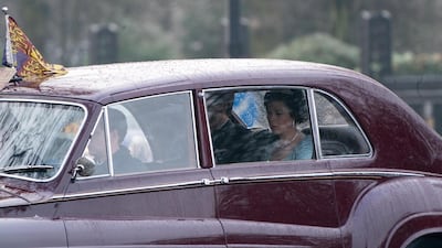 A second image of Olivia Colman shows the actress playing a solemn Queen Elizabeth II driving though London. Previously, Colman was filming at the Royal College of Physicians in London, England. Splash News