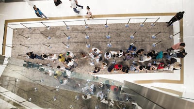 People wait in a queue to purchase the new iPhone XS at the Apple store in Dubai Mall, 12 hours before it goes on sale. Leslie Pableo / The National