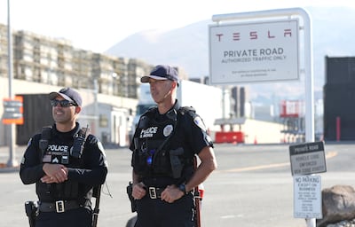 Fremont police officers stand guard in front of the Tesla manufacturing facility. AFP