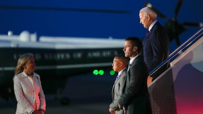 He is greeted by Jane Hartley, US ambassador to the UK, at the airport. AP