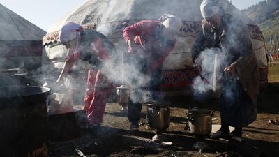 Women prepare the stoves ready to cook breakfast, at the World Nomad Games – dedicated to Central Asian sports – in Kyrchyn Gorge, Kyrgyzstan, last month. Kyrgyzstan is fast becoming a prime destination for outdoor pursuit enthusiasts. Olivia Harris / Getty Images.