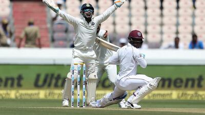 Indian wicketkeeper Rishabh Pant successfully appeals for the dismissal of West Indies' player Shimron Hetmyer, bowled by Kuldeep Yadav, during the first day of the second cricket test match between India and West Indies in Hyderabad, India.