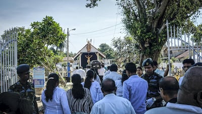 Mourners enter Bolowalana cemetery for a burial in Negombo. Jack Moore / The National.