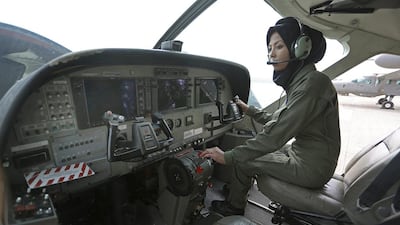 Capt Safia Ferozi, 26, sitting in a C-208, a turboprop plane used as transport for the armed forces, before a flight, at the Afghan military airbase in Kabul, Afghanistan. Rahmat Gul/AP Photo