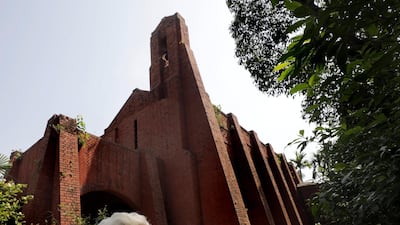 n elderly person uses a protective face mask as he stands guard near a closed church on Good Friday during lockdown near Kolkata, India. EPA
