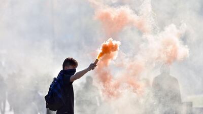 A youth holds a flare during a protest against the government’s planned labour law reforms in Nantes, western France. High school pupils and workers protested against deeply unpopular labour reforms that have divided the Socialist government and raised hackles in a country accustomed to iron-clad job security. Loic Venance / AFP