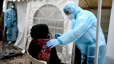 Medical personnel conduct a test in Berlin, Germany. AP Photo